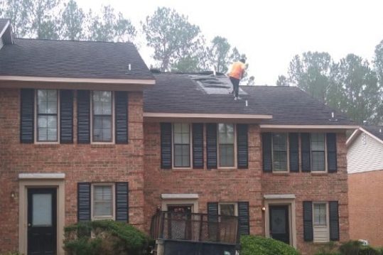 Man on Tudor Roof- Asphalt Shingles